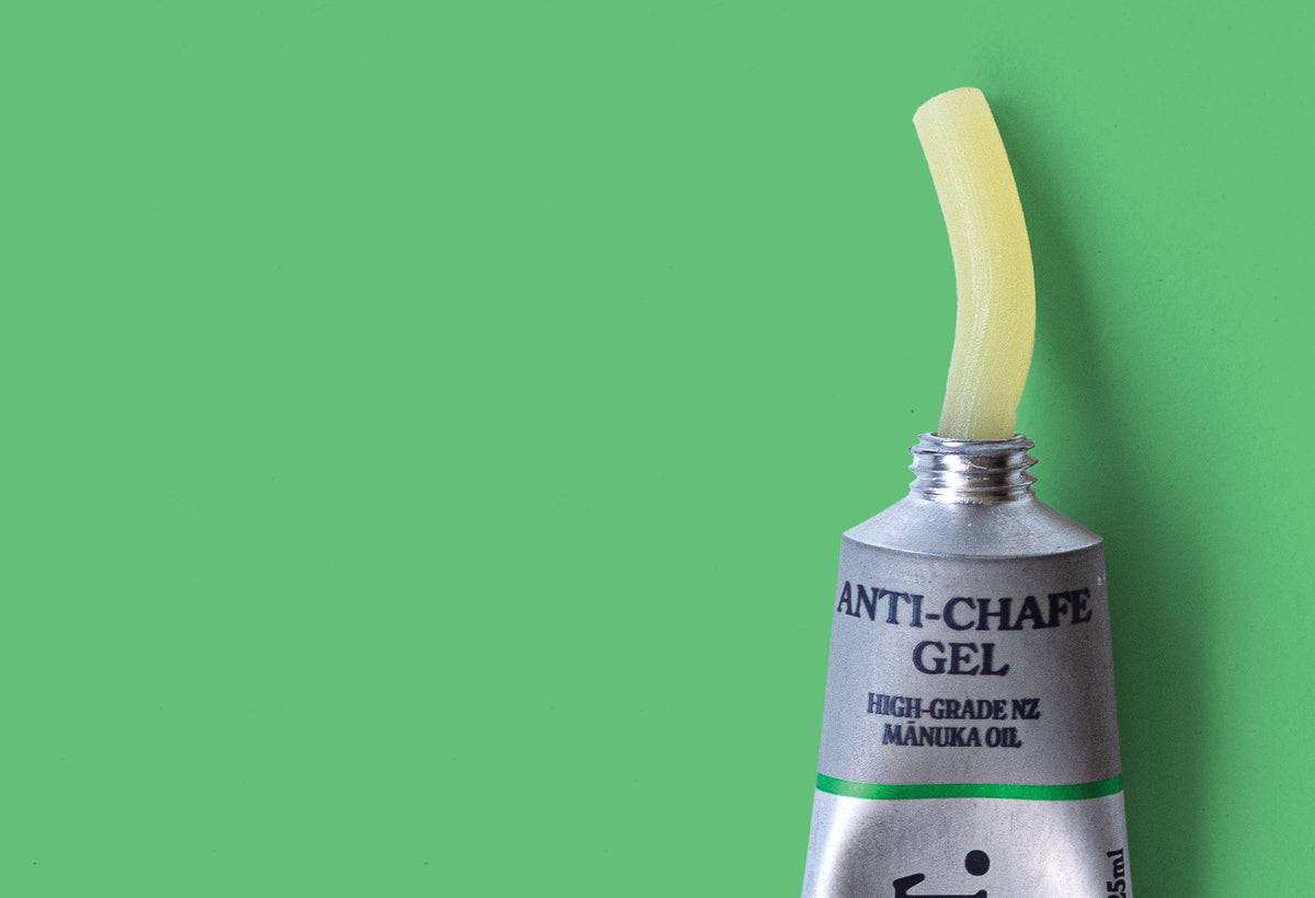 Tube of anti-chafe gel with a line of dispensed gel on a green background